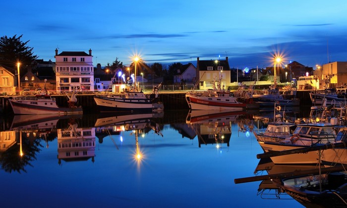 Boats docked in a harbor at Grandcamp-Maisy, Calvados, France at dusk