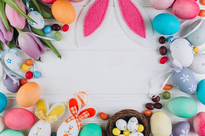 Easter Eggs and Tulips on White Wood Background