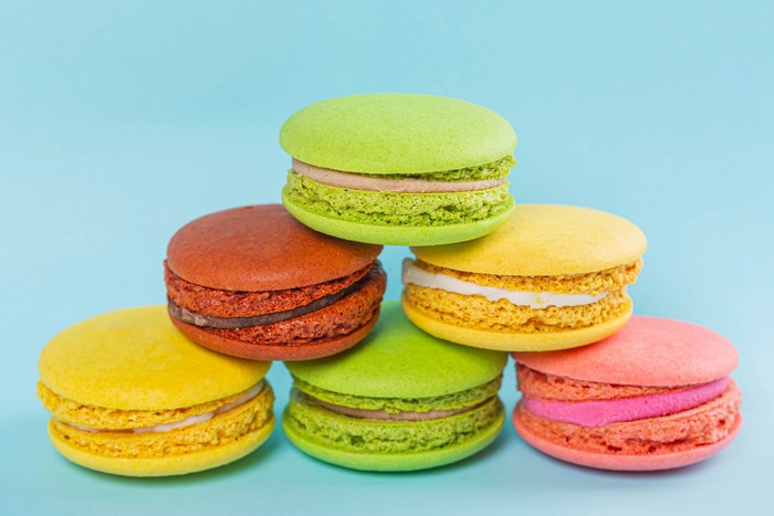 Stack of colorful macarons on a blue background