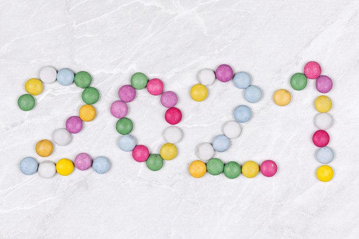 2021 made of colorful candies on a marble background