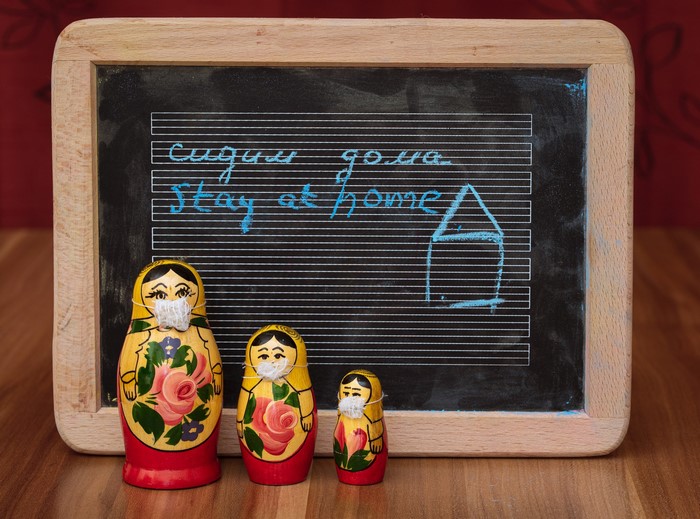 Matryoshka dolls with masks in front of chalkboard