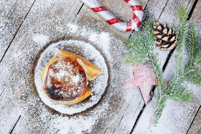 Baked apple with powdered sugar and Christmas decorations