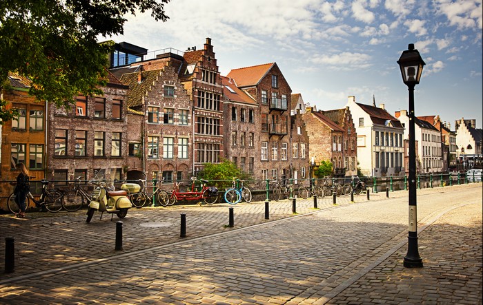 Ghent, Belgium: Canal-side buildings with bicycles and scooter