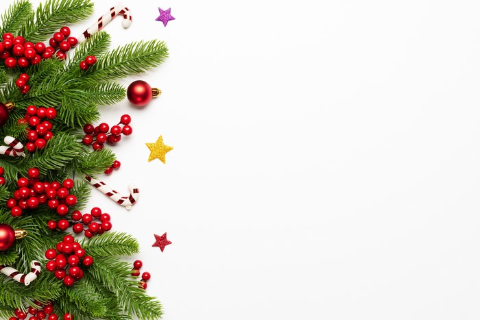 Christmas branches with berries and ornaments on white background