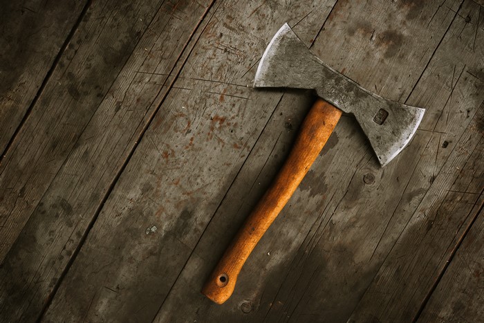 Double-headed axe on wooden planks