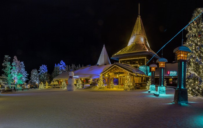 Christmas village with snowmen and Christmas tree at night