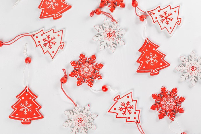 Christmas tree and snowflake ornaments on gray background