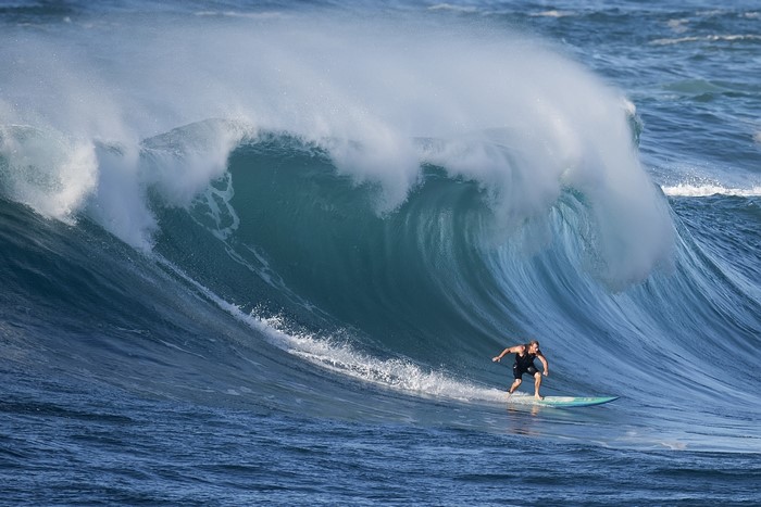 Surfer David H Yang rides a massive wave