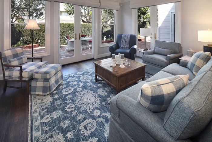 Living room with sofa, armchair, and carpet