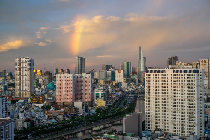 Ho Chi Minh City skyline with rainbow over river