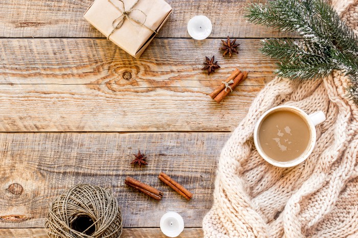 Christmas flat lay with gift, coffee, and cinnamon