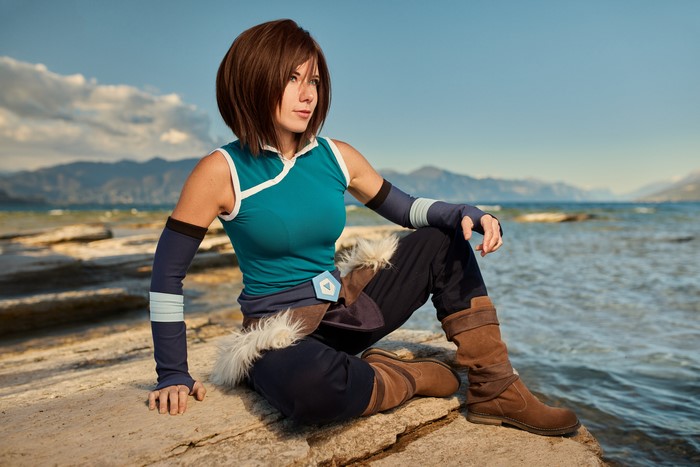 Korra from Avatar Cosplay Sitting on Stones by Lake