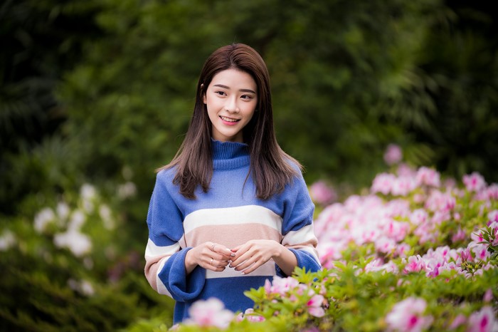 Asian woman with brown hair wearing a sweater