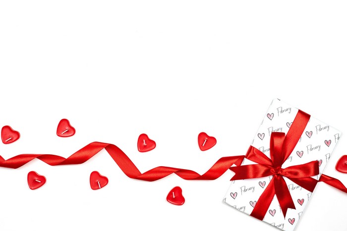 Valentine's Day gift with red ribbon and heart candles