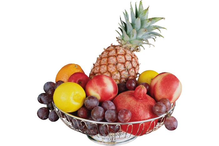 Fruit basket with pineapple, grapes, lemons, and apples