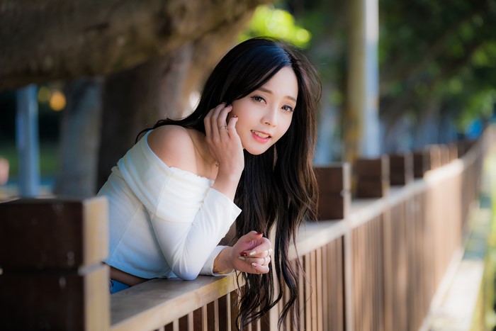 4K Portrait of Asian Brunette Girl by Fence