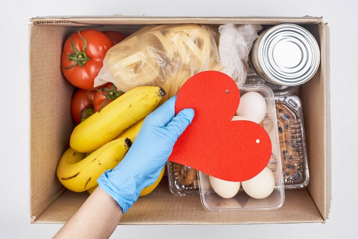 Food box with tomatoes, bananas, eggs, and a heart