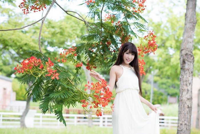 4K Brunette Girl Smiling Among Red Blossoms