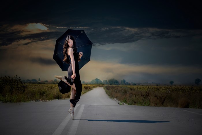 Ballerina with Umbrella on a Road
