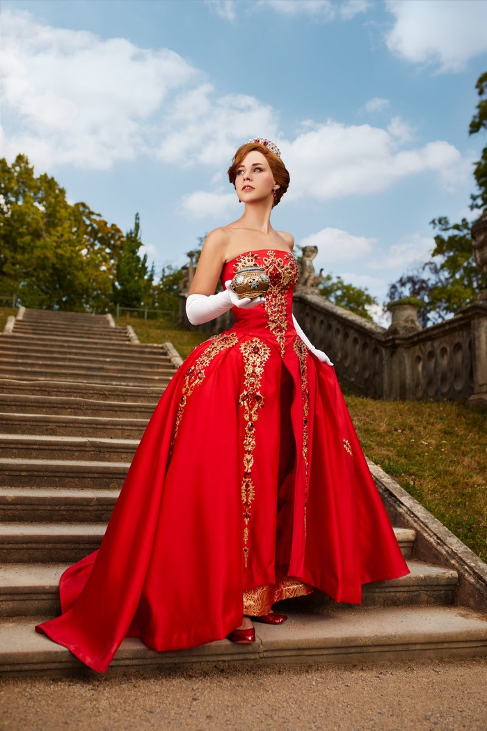 Anastasia in a red dress on stairs