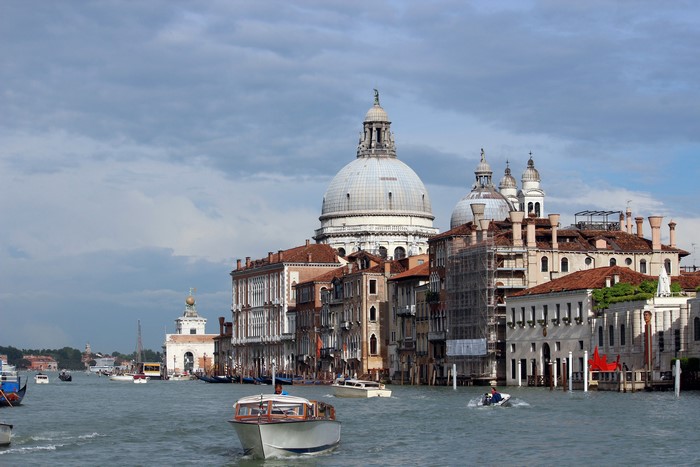 Grand Canal in Venice, Italy with motorboats and cathedral