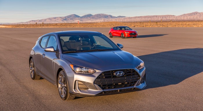Grey and Red Hyundai Veloster Hatchbacks on Road