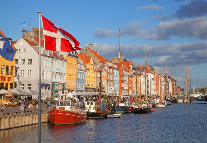 Nyhavn Canal in Copenhagen, Denmark with Danish Flag