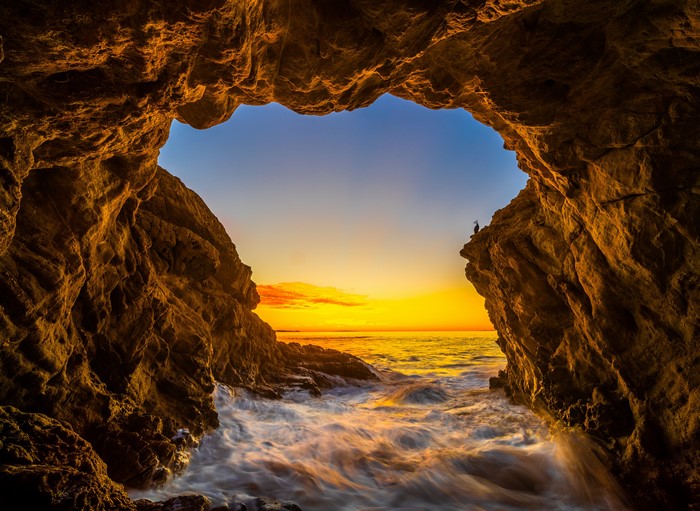 Cave entrance at El Matador Beach, California during sunset