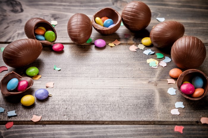 Chocolate Easter Eggs with Dragees on Wooden Table