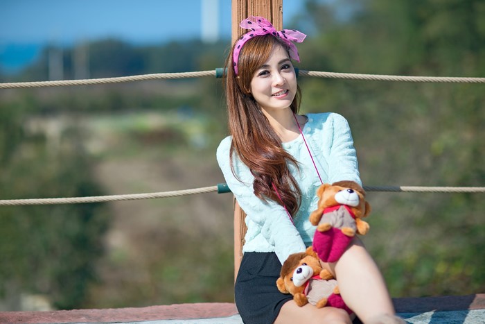 Asian girl with bowknot and toys