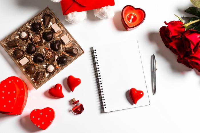 Valentine's Day chocolates, roses, notepad, and pen