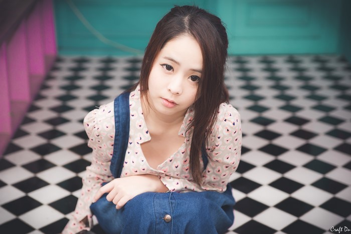 Asian girl with brown hair looking at the camera