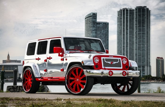 Silver and red custom Jeep Wrangler with large red rims