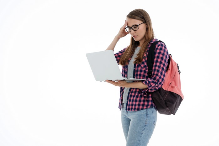 Female student with laptop and backpack