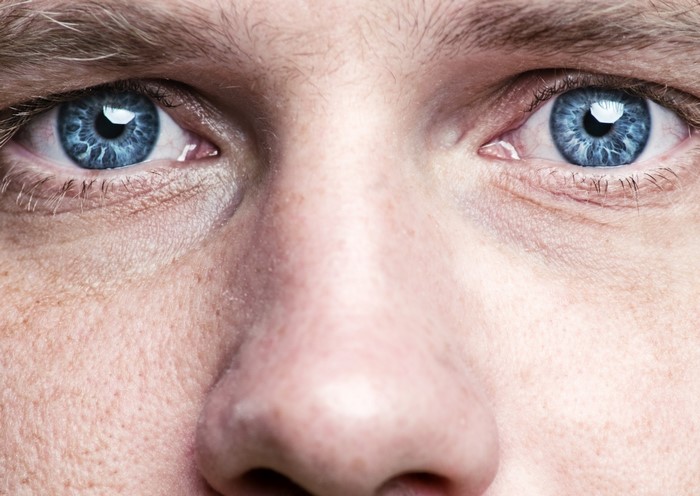 Close-up of a man's blue eyes and nose