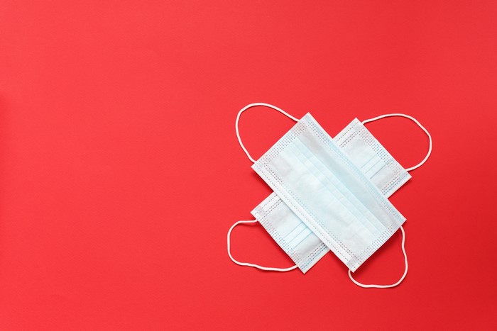 Two medical masks on a red background