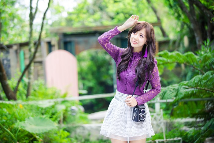 Asian girl with vintage camera in park