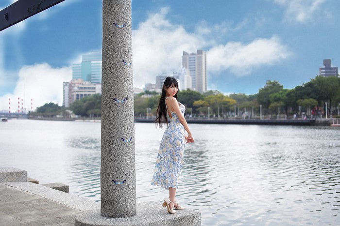 Brunette girl in dress by the river