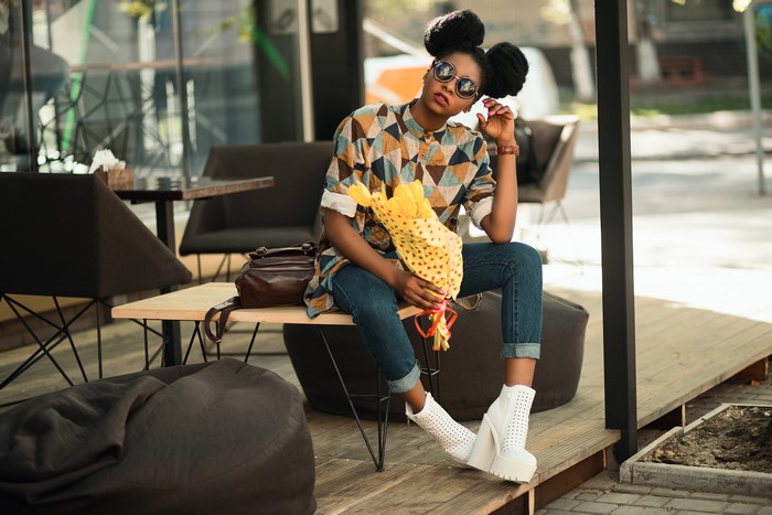 Woman with buns hairstyle holding bouquet