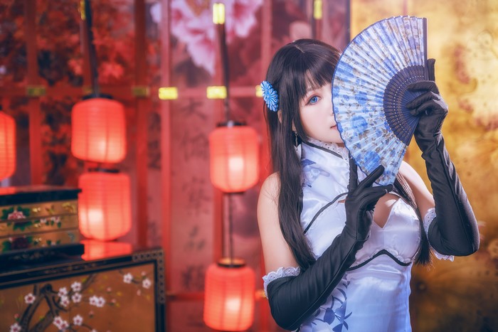 Brunette girl with hand fan and gloves