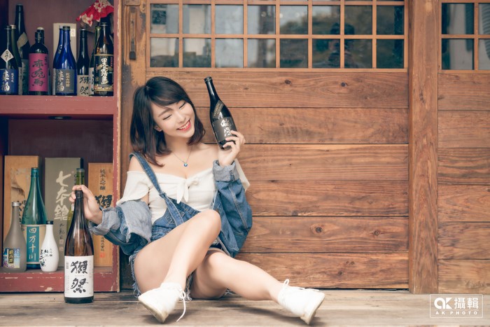 Asian woman with sake bottles