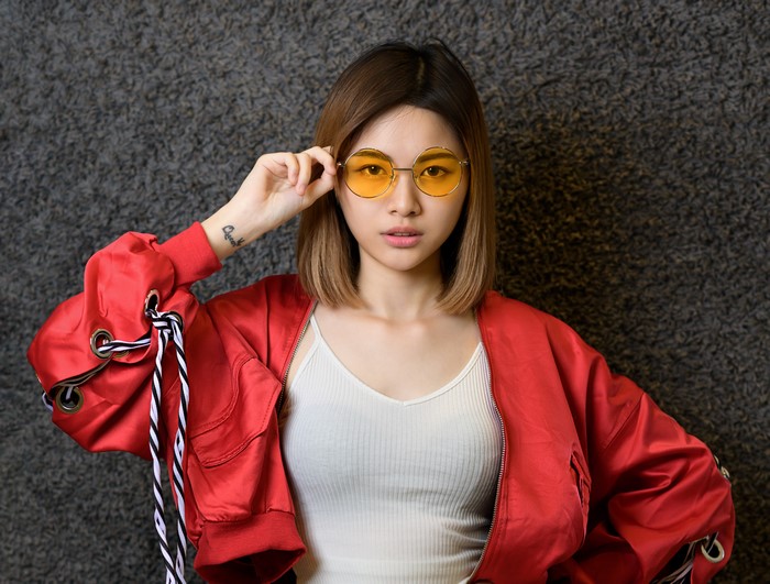 Young Woman in Red Jacket with Yellow Glasses