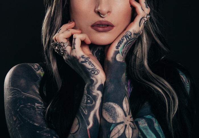 Woman with extensive tattoos and piercings
