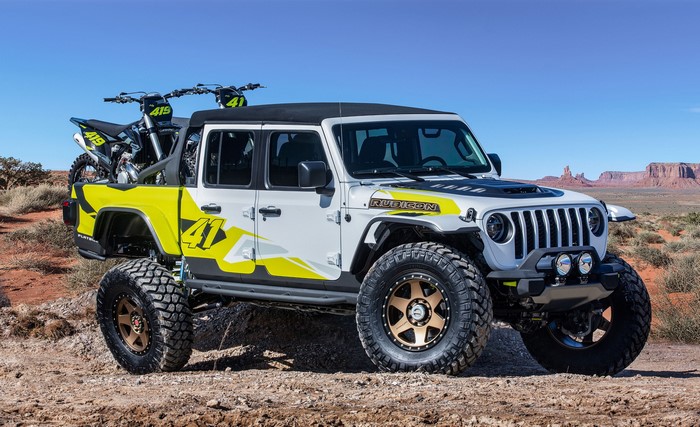 Jeep Gladiator Rubicon with dirt bikes in desert landscape