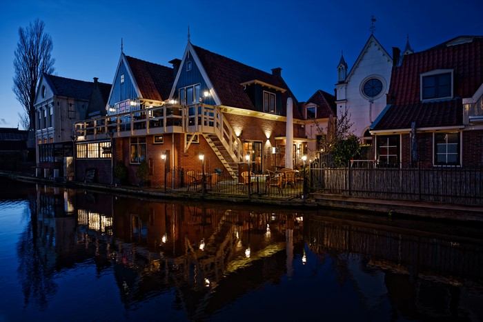 Houses at night by canal in De Rijp, Netherlands