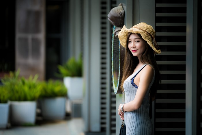 Asian woman wearing a straw hat and dress