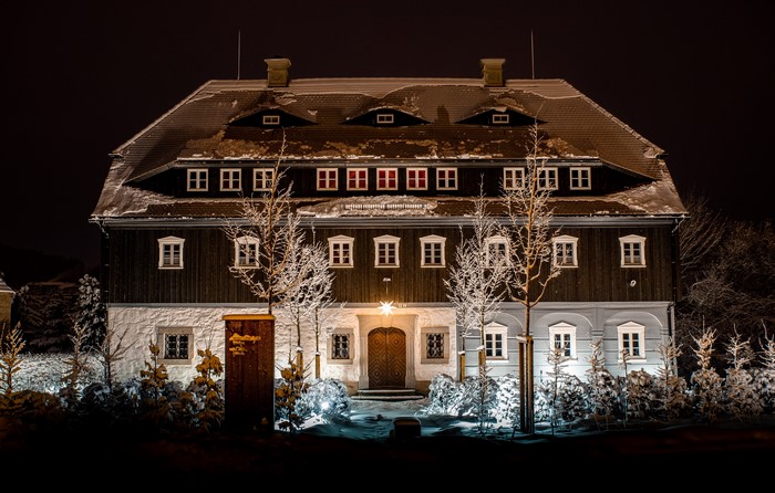 Snowy mansion at night in Austria