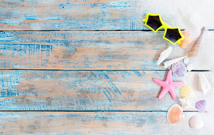 Starfish and sunglasses on weathered wood planks