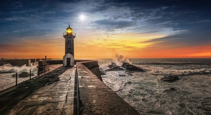 Lighthouse on the coast of Porto at sunset