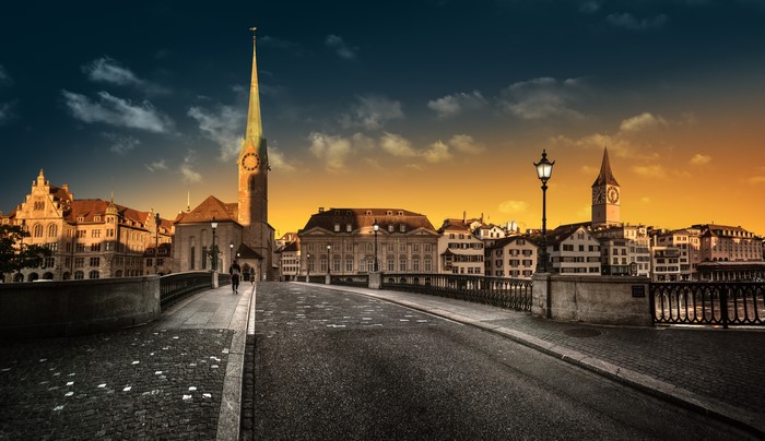 Zurich cityscape with churches and bridge at sunset